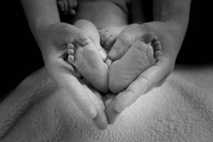 Mother touching her baby's feet